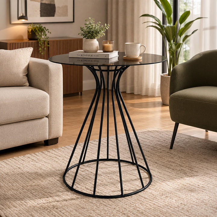 Metal round side table with curved tubular base